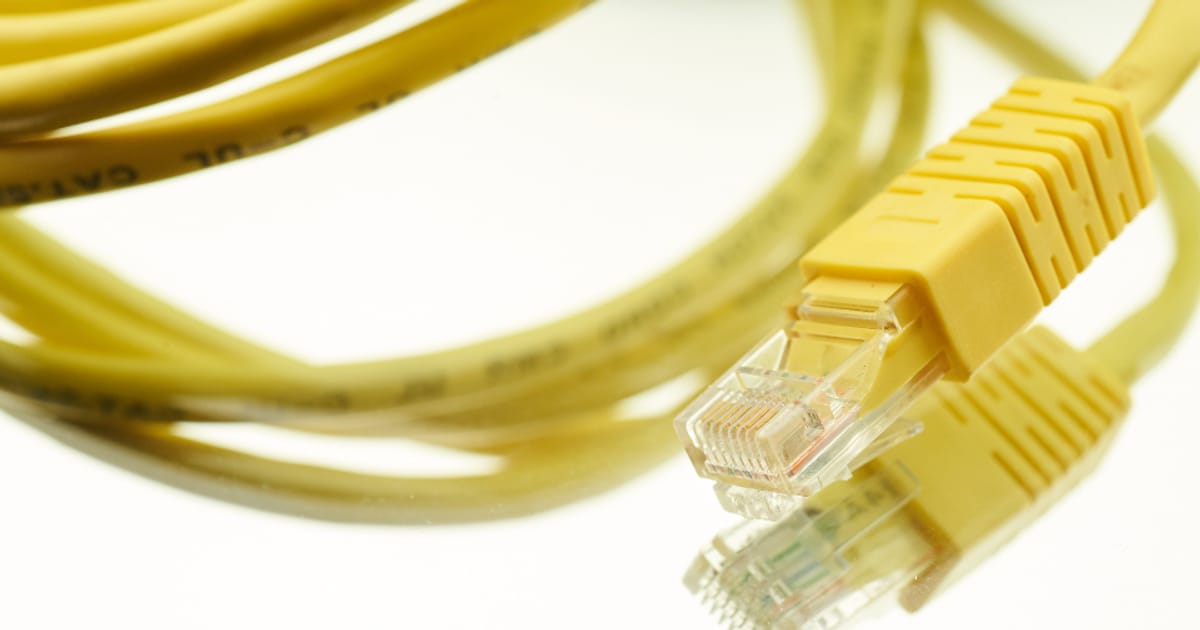 Network cables plugged into networking hardware